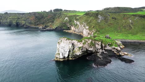 Aerial-dolly-shot-over-the-stunning-cliffs-on-a-majestic-coastline-from-Kibane-Castle-in-Northern-ireland-along-the-giant-Causeway-coastal-road-during-an-exciting-journey-through-the-country