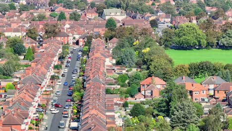 Cars-drive-down-tight-street-lined-with-town-homes-in-Doncaster-England