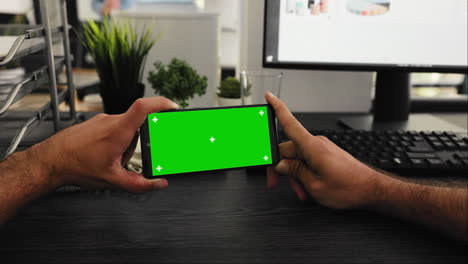 POV-worker-holds-phone-with-greenscreen