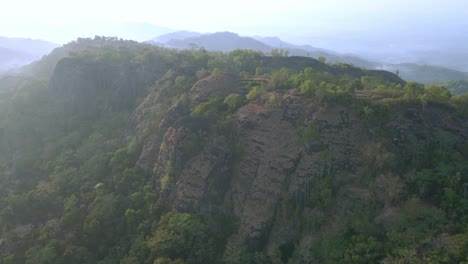 Birds-Eye-view-aerial-flying-over-pre-historic-volcano-of-Nglangeran,-Indonesia-at-day