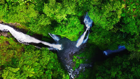 Fiji-waterfalls-falling-over-cliff-to-lush-rainforest-pool-in-Bali