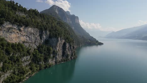 Aerial-view-of-Walensee's-mountain-shoreline-on-a-sunny-day-with-blue-waters