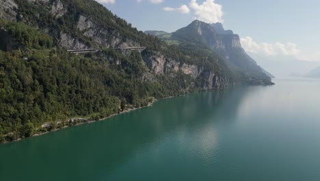 A-beautiful-day-with-sun-haze-and-turquoise-waters-near-the-mountain-shoreline-of-Walensee