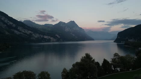 A-magnificent-view-of-Walensee-Lake-amidst-mountain-scenery-and-a-pink-blue-morning-sky