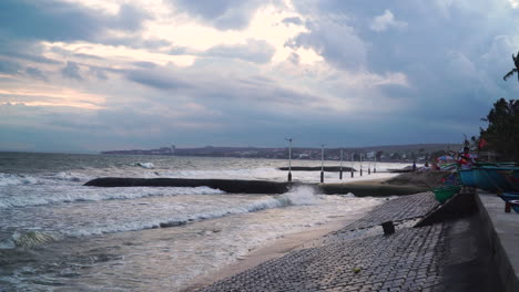 Stormy-Ocean-Waves-Crash-Against-Seawall-and-Sandbag-Barrier