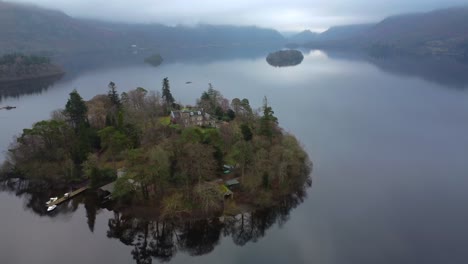 Aerial-drone-video-of-a-lake-on-a-grey-and-cloudy-day---taken-at-Derwent-Water-Keswick,-Lake-District