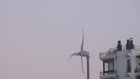 Wind-turbines-in-action-in-residential-areas,-generating-green-energy-to-help-preserve-the-planet