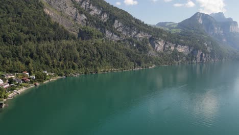 An-astonishing-journey-across-Lake-Walensee,-with-its-green-waters,-picturesque-villages,-and-stunning-mountain-views