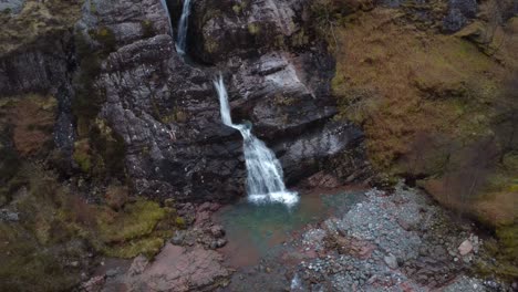 Aerial-drone-video-in-4K-of-a-waterfall-in-Glencoe-valley,-Scotland