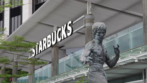 Western-starbucks-cafe-next-to-Bruce-Lee-bronze-memorial-statue-at-Tsim-Sha-Tsui-Hong-Kong