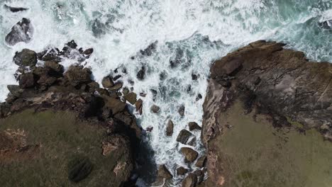 Waves-crash-against-a-rugged-Australian-coastal-headland-and-hidden-rocky-cove