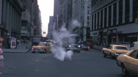 Busy-New-York-Street-Corner-in-1970s-with-Cars-and-Yellow-Taxies