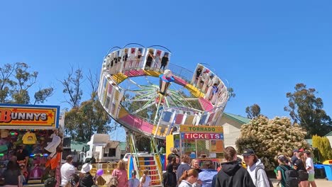 Yarrawonga,-Victoria,-Australia---7-October-2023:-View-of-people-watching-others-riding-on-the-spinning-Tornado-ride-at-the-Yarrawonga-Show-in-Victoria-Australia