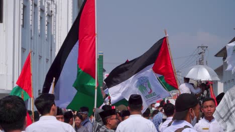 Asian-group-of-protesters-waving-Palestinian-flag-for-independence-against-Israel-and-Hamas,-close-up