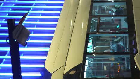 Vertical-video-of-electric-bus-charging-in-the-city-at-night---Public-transport,-clean-energy---Brussels,-Belgium