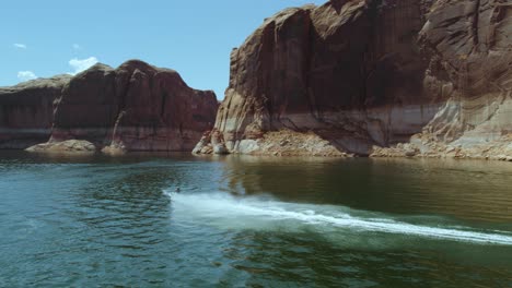 Jet-Ski-Waverunner-by-Lake-Powell-Canyon-Cliffs-in-Beautiful-Canyon,-Aerial