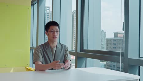 Young-Man-Speaking-to-Camera-for-an-interview-in-Office