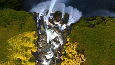 Top-down-aerial-view-of-scenic-river-mossy-waterfall-in-Iceland
