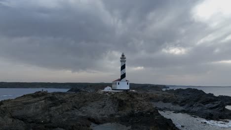 A-zoomed-out-view-of-the-Favàritx-Lighthouse-on-a-cloudy-day,-Menorca