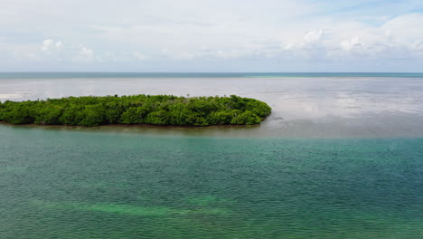 Aerial-panoramic-view-of-alone-island-with-green-vegetation-in-wide-sea
