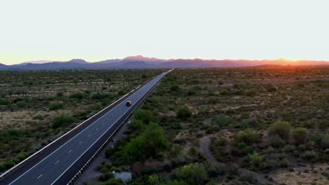 Scenic-road-through-Arizona-desert-valley,-concept-travel-in-the-sunset