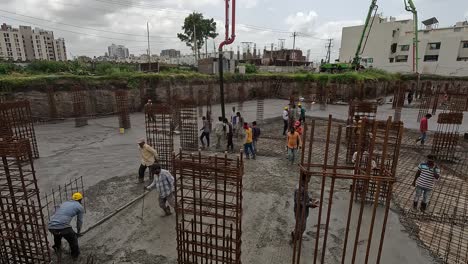 Vista-Aérea,-Se-Están-Realizando-Trabajos-De-Construcción-De-Un-Edificio-De-Gran-Altura-En-El-Que-Se-Está-Construyendo-El-Sótano-Y-Se-Está-Rellenando-Hormigón-Y-Cemento