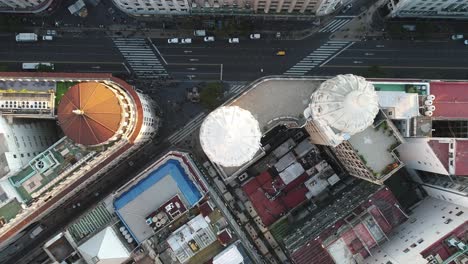 Aerial-view-that-captures-the-urban-landscape,-of-a-dome,-with-vehicular-activity-and-pedestrians-in-motion