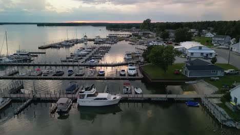 Aerial-flyover-hessel-marina-at-dusk,-Michigan