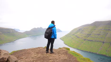 Male-content-creator-stretches-arms-out-to-celebrate-visiting-Faroe-islands