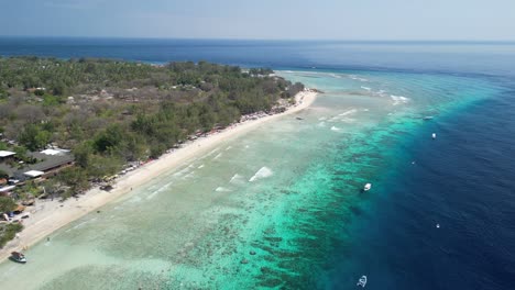 Aerial-over-Gili-Trawangan-East-Beach,-nestled-in-Indonesia,-an-slice-of-tropical-heaven-that-beckons-travelers-with-its-tranquil-beauty-and-serene-charm