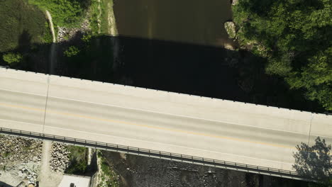 Overhead-View-Of-River-and-Concrete-Bridge-On-A-Sunny-Day