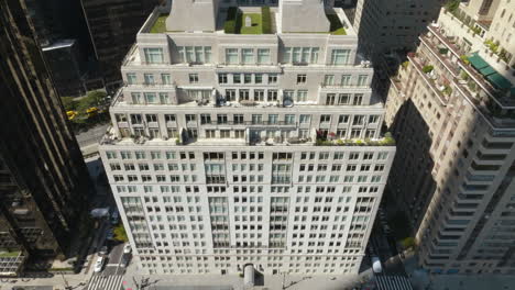 Aerial-tilt-shot-descending-in-front-of-the-15-Central-park-west,-in-sunny-NYC