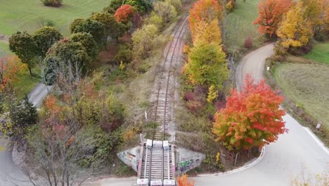 Aerial-Flyover-Of-Train-Bridge-And-Road-In-Caledon-During-Fall