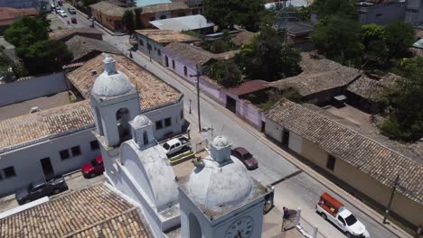 Low-aerial-orbits-San-Marcos-catholic-church-facade-and-bell-towers
