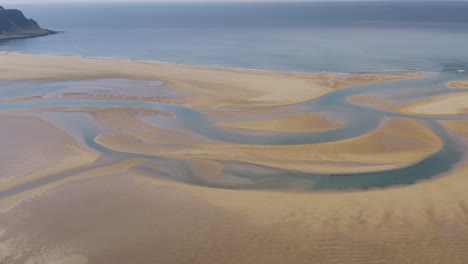 Aerial-birds-eye-shot-of-sandy-Raudasandur-beach-and-ocean-in-background-in-summer---Iceland,-Europe