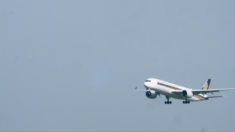 Preparing-for-landing,-the-Singapore-Airlines-lowered-its-landing-gear-to-get-ready-to-hit-the-runway-for-a-safe-landing-at-Suvarnabhumi-airport-in-Bangkok,-Thailand