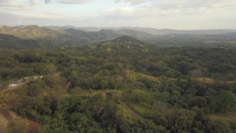 Smooth-drone-shot-turning-over-lush-green-hills-and-mountains