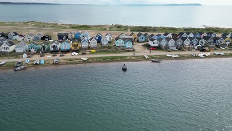 Low-panning-drone,aerial-Beach-huts-Mudeford-Sandbank-Christchurch-UK