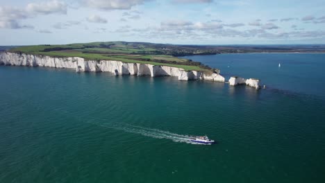 Aerial-Shot-of-Passenger-Tour-Boat-Ferry-around-Old-Harry-Rocks,-Jurassic-Coast,-Great-Britain