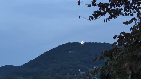 Vista-Mirando-La-Brillante-Estrella-Roanoke-Iluminada-En-El-Lado-De-La-Montaña-Blue-Ridge-Por-La-Noche
