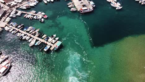 Yachts-docked-in-pier-near-Chania-city,-aerial-view