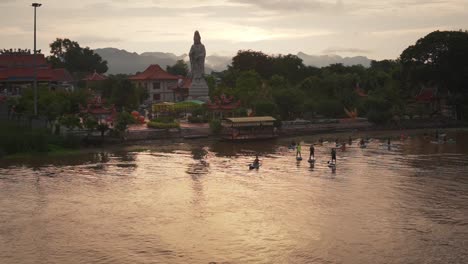 Peaceful-Evening-Paddleboarding-in-Kanchanaburi,-Thailand