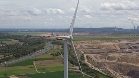 A-lone-wind-turbine-near-the-Garzweiler-mine,-overlooking-the-highway