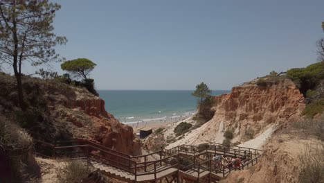 Scenic-Steps-Through-Cliffs-Leading-To-Sandy-Beach-In-Olhos-de-Agua,-Albufeira,-Portugal