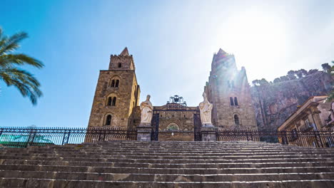Cefalù-Cathedral-on-a-sunny-summer-day-with-sun-behind-tower,-time-lapse-view