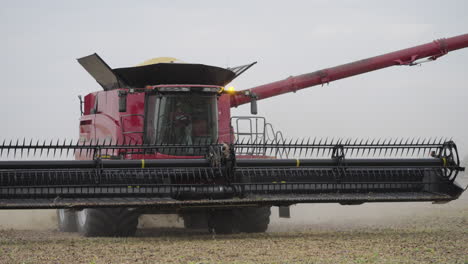 Combine-Harvester-Gathering-Soybeans-in-a-Farm-Field-and-Lifting-Header
