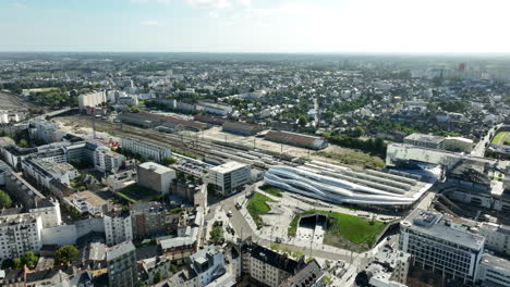 Rennes-City-Modern-Railway-Train-Station,-Sunny-Day,-Aerial-Pullback