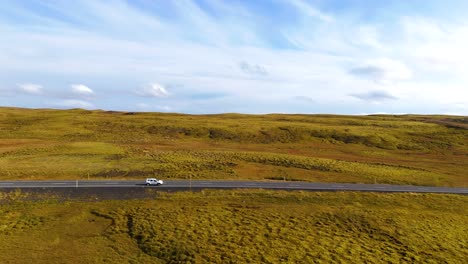 Aerial-tracking-shot-of-tourists-driving-towards-popular-locations-within-Iceland