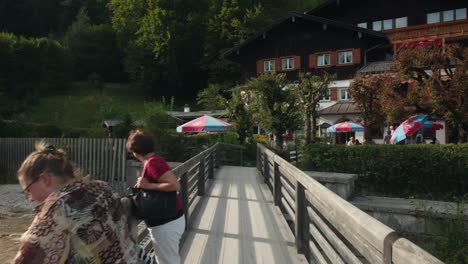 Old-women-relax-on-bridge-outside-of-scenic-resort-visitors-center-near-Almbachklamm