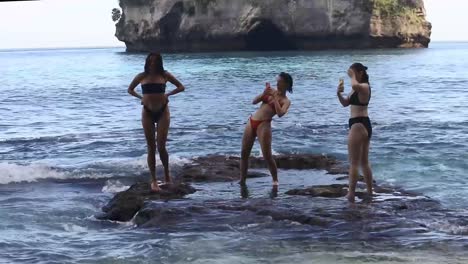 Foto-De-Turistas-Tomándose-Selfies-En-El-Borde-De-La-Playa-Diamond-En-Nusa-Penida,-Bali.